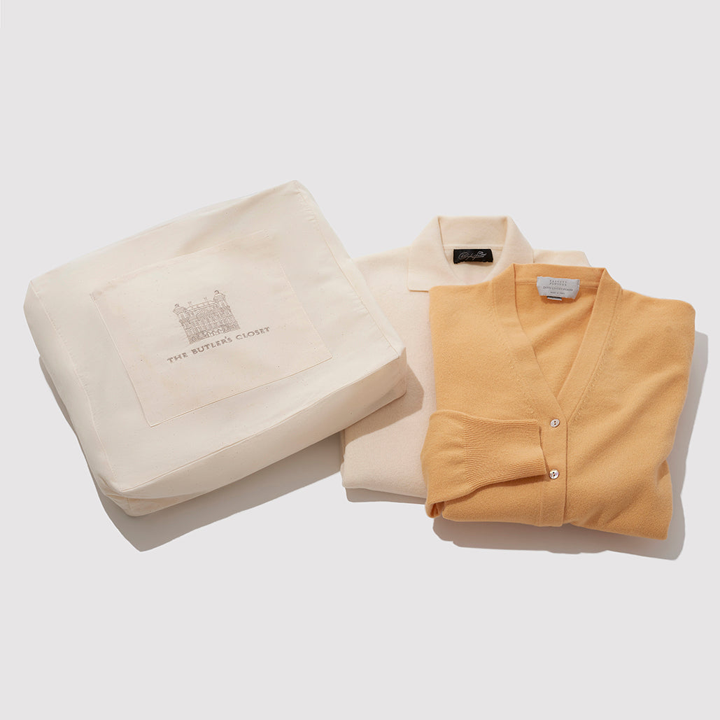 A Cotton Garment Bag With An Orange And White Shirt Folded Beside It